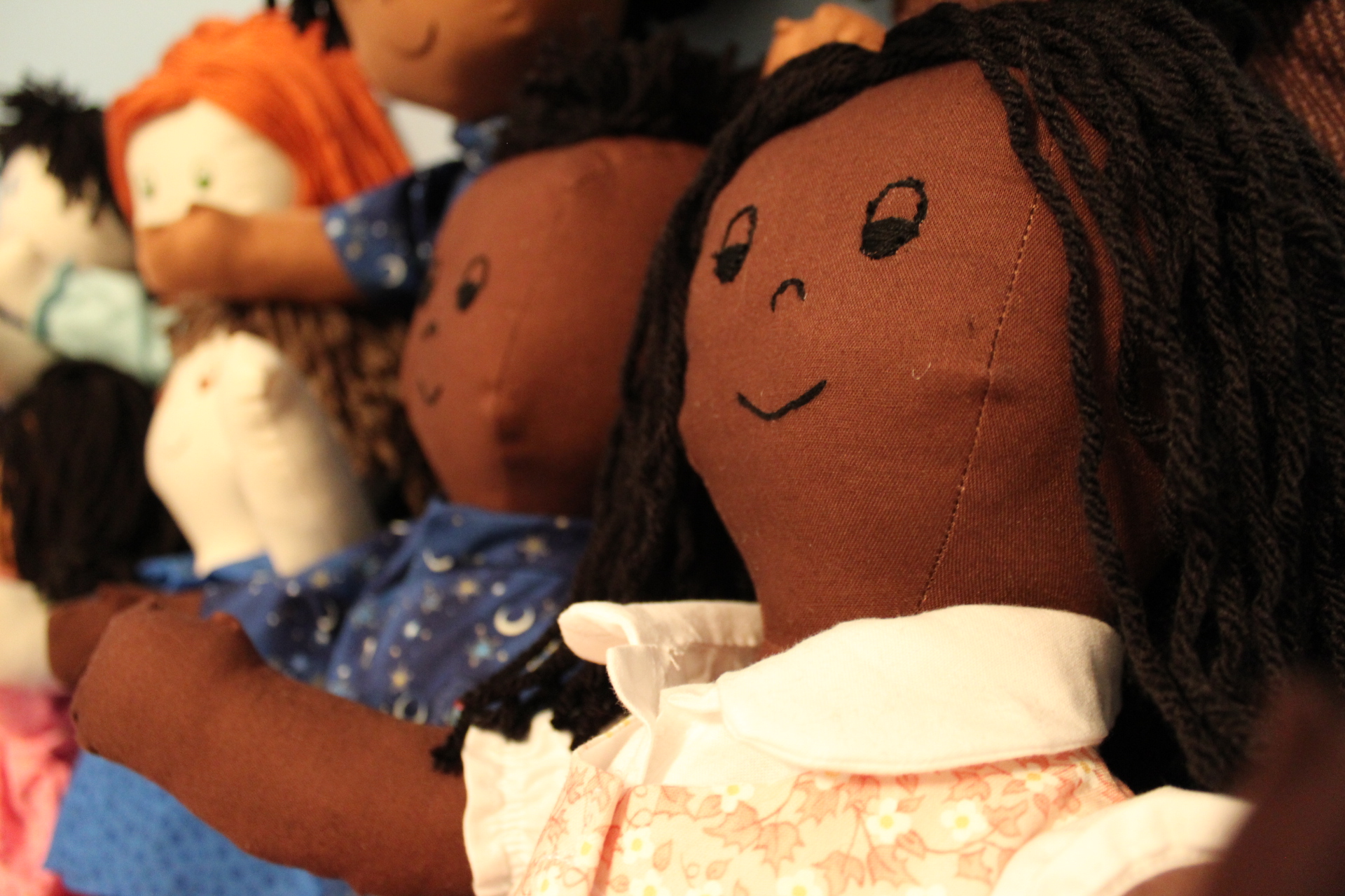 A closeup of several Comfort Kid dolls